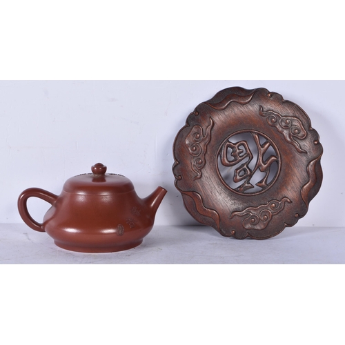 3229 - A Chinese Yixing teapot with a fitted Hardwood stand 9 x 14cm (2)