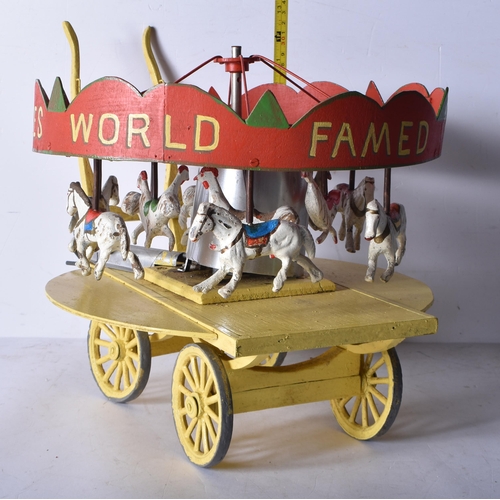 3261 - An early 20th Century folk art scratch built wooden and metal model carousel with painted lead and m... 