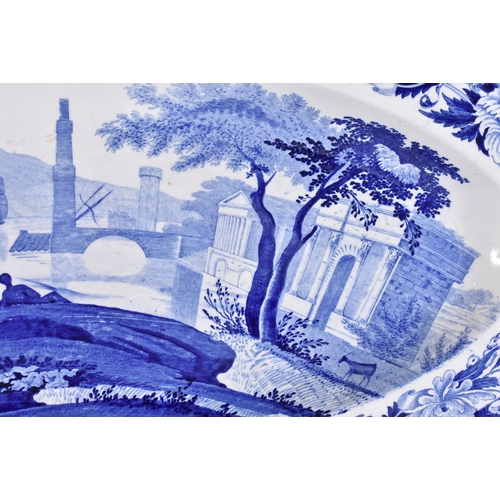 100 - AN UNUSUAL LARGE EARLY 19TH CENTURY WEDGWOOD BLUE AND WHITE DISH decorated with scenes of figures an... 