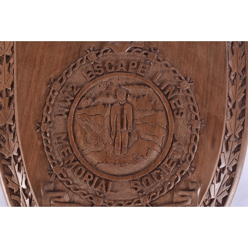 102 - AN UNUSUAL MILITARY INTEREST TREEN WWII ESCAPE LINES MEMORIAL PLAQUE. 28 cm x 18 cm.