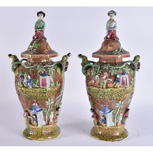 103 - A RARE LARGE PAIR OF 19TH CENTURY MAJOLICA VASES AND COVERS unusually formed with Chinese figures an... 