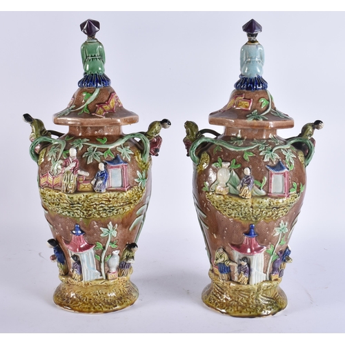 103 - A RARE LARGE PAIR OF 19TH CENTURY MAJOLICA VASES AND COVERS unusually formed with Chinese figures an... 