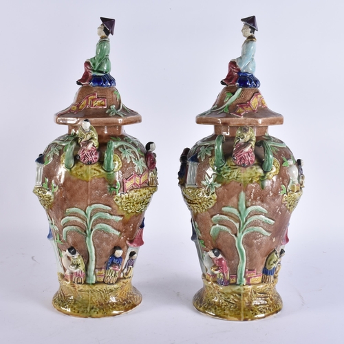 103 - A RARE LARGE PAIR OF 19TH CENTURY MAJOLICA VASES AND COVERS unusually formed with Chinese figures an... 