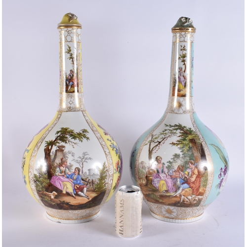 104 - A VERY LARGE PAIR OF 19TH CENTURY GERMAN PORCELAIN BOTTLE VASES AND COVERS painted with lovers in la... 