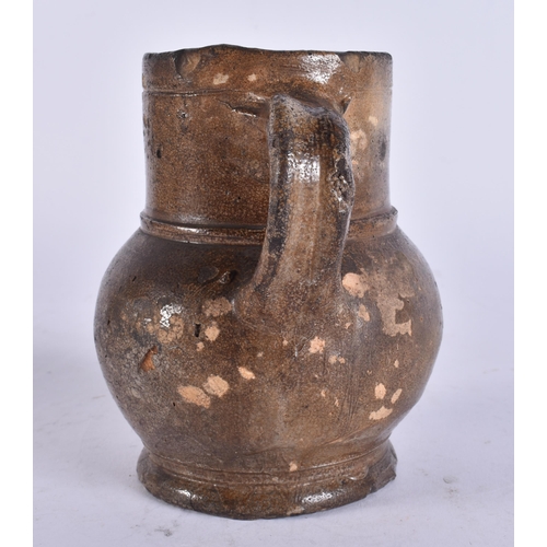 135 - A 17TH/18TH CENTURY ENGLISH STONEWARE TAVERN MUG. 13 cm high.
