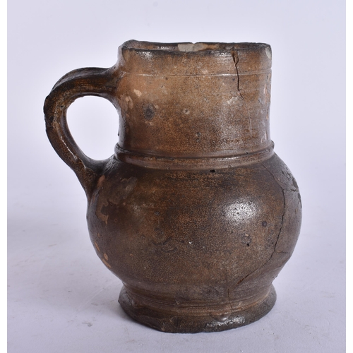 135 - A 17TH/18TH CENTURY ENGLISH STONEWARE TAVERN MUG. 13 cm high.