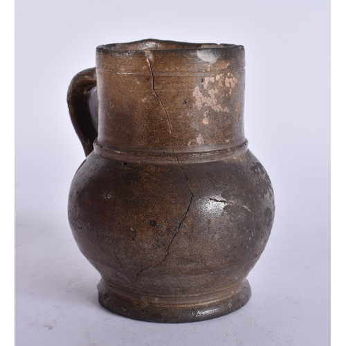 135 - A 17TH/18TH CENTURY ENGLISH STONEWARE TAVERN MUG. 13 cm high.