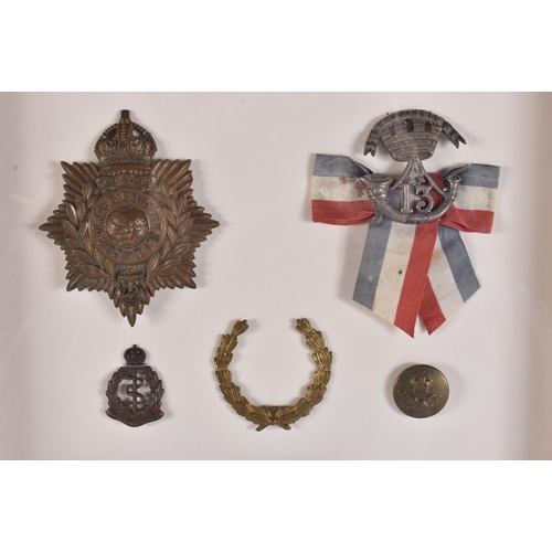 161 - A FRAMED MILITARY MEDAL GROUP including a Royal marines helmet plate & insignia, a Somerset light in... 