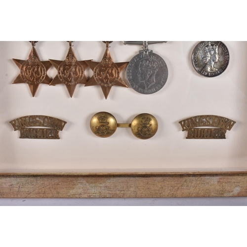 161 - A FRAMED MILITARY MEDAL GROUP including a Royal marines helmet plate & insignia, a Somerset light in... 