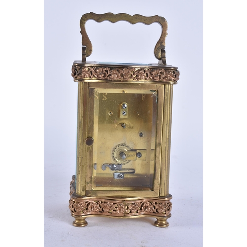 84 - AN ANTIQUE FRENCH FILIGREE CARRIAGE CLOCK. Not running. 15 cm high inc handle.