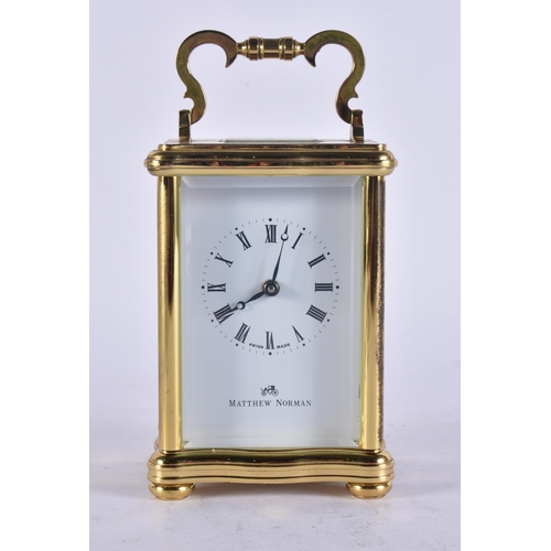 85 - A MATTHEW NORMAN CARRIAGE CLOCK. Working. 14 cm high inc handle.