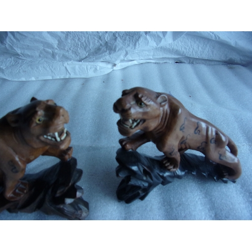 13 - Pair of hand carved tiger mantel ornaments