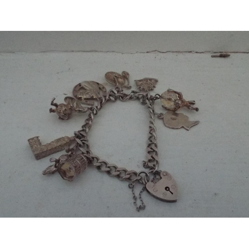 142 - Silver charm bracelet