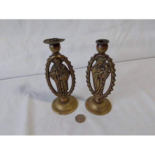 35 - pair of religious brass candle sticks