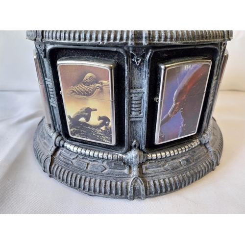 23 - 8 Alien Zippo lighters all unused with display stand (A/F)