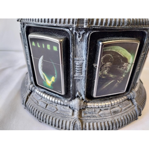 23 - 8 Alien Zippo lighters all unused with display stand (A/F)