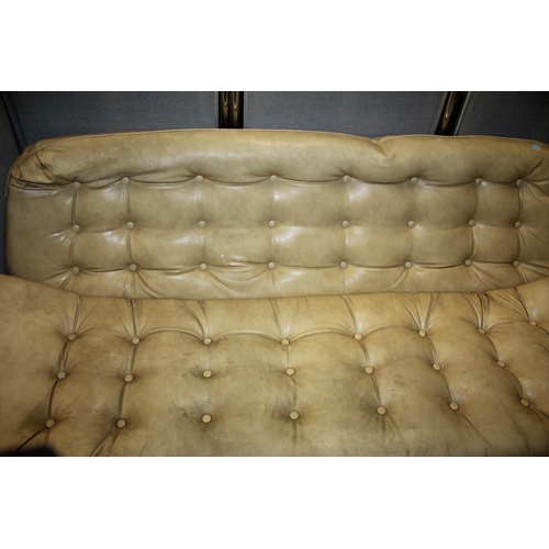 229 - CREAM VINYL STUDDED SOFA WITH CONVEX CURVE BASE (W74