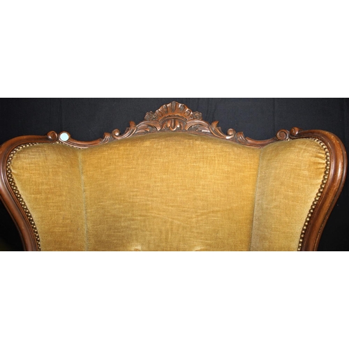 98 - LARGE UPHOLSTERED ARMCHAIR WITH CARVED WOODEN FRAME