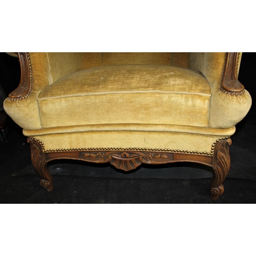 98 - LARGE UPHOLSTERED ARMCHAIR WITH CARVED WOODEN FRAME