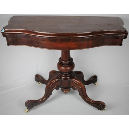 140 - MAHOGANY FOLD OVER CARD TABLE ON PEDESTAL BASE WITH SCROLLED LEGS