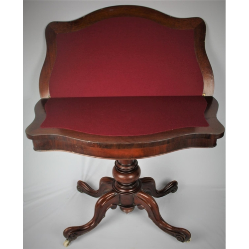 140 - MAHOGANY FOLD OVER CARD TABLE ON PEDESTAL BASE WITH SCROLLED LEGS