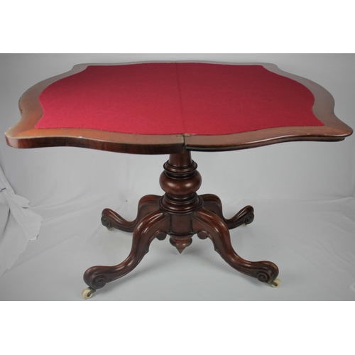 140 - MAHOGANY FOLD OVER CARD TABLE ON PEDESTAL BASE WITH SCROLLED LEGS