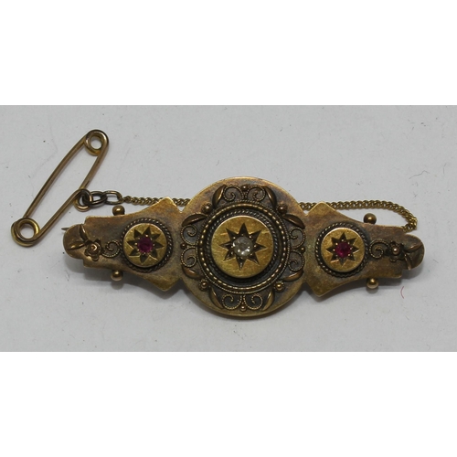 360 - GOLD BROOCH STAMPED 15ct SET SINGLE CENTRAL DIAMOND & 2 RUBIES (4.9g)