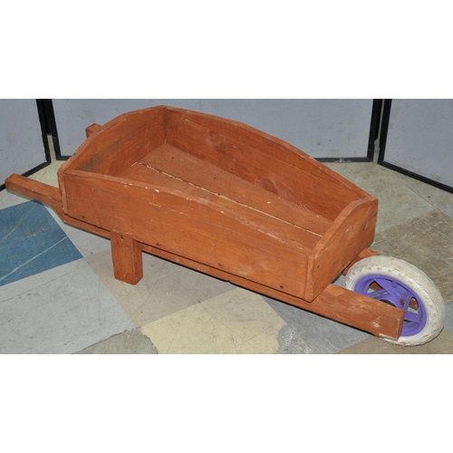 228 - 2 WOODEN WHEELBARROWS PLANTERS - ONE BROWN, ONE BLACK