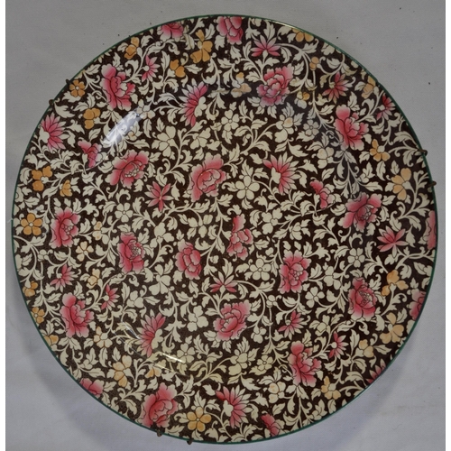 381 - PINK AND BROWN DECORATED PORCELAIN PLATE - LABEL ON REVERSE 