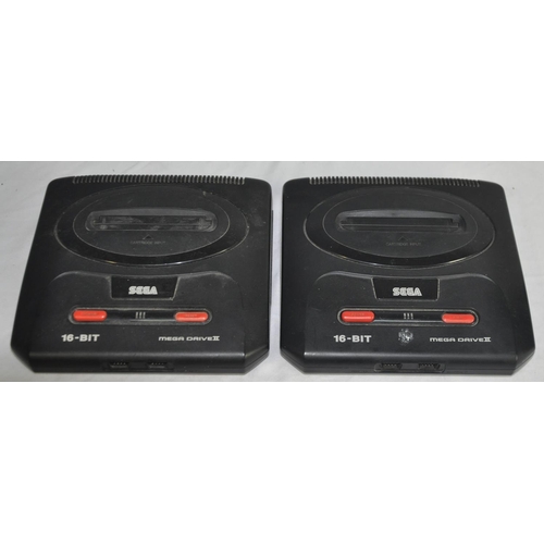 228 - 2 SEGA MEGA DRIVES II, 4 CONTROL PADS, 2 AC POWER SUPPLY, 7 BOXED AND 3 LOOSE GAMES