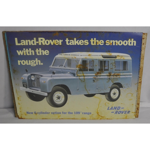 123 - 4 TIN ADVERTISMENT PLAQUES - TRUIMPH HERALD, MORRIS TRAVELLER, LAND ROVER AND ROYAL ENFIELD