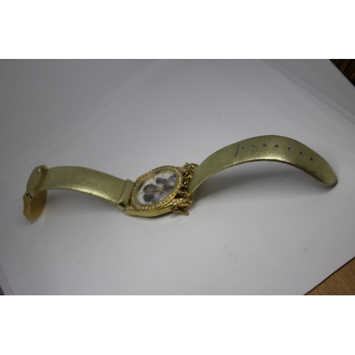 425 - 2 LADIES WATCHES: GOLD COLOURED ANGEL WATCH & GOLD COLOURED BRACELET WATCH WITH STONE SET FACE