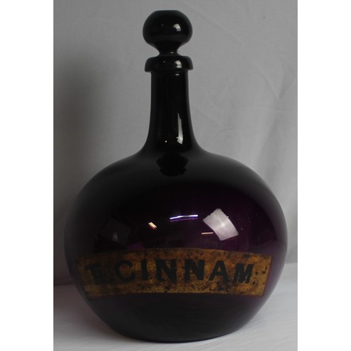 335 - LARGE CHEMIST APOTHECARY BOTTLE WITH TAPERING NECK AND BULBOUS BODY - LABEL FOR TR CINNAM