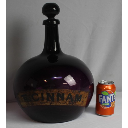 335 - LARGE CHEMIST APOTHECARY BOTTLE WITH TAPERING NECK AND BULBOUS BODY - LABEL FOR TR CINNAM