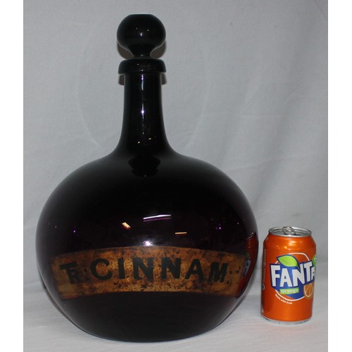 335 - LARGE CHEMIST APOTHECARY BOTTLE WITH TAPERING NECK AND BULBOUS BODY - LABEL FOR TR CINNAM