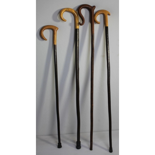 42 - BRASS UMBRELLA STAND AND BUNDLE OF WALKING STICKS