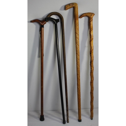 42 - BRASS UMBRELLA STAND AND BUNDLE OF WALKING STICKS