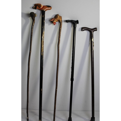 42 - BRASS UMBRELLA STAND AND BUNDLE OF WALKING STICKS