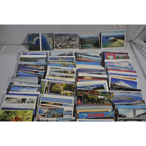 257 - BOX OF POSTAL ENVELOPES WITH STAMPS AND BOX OF POSTCARDS WITH STAMPS