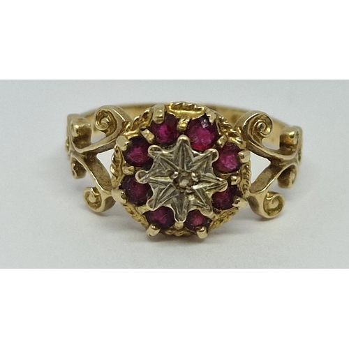 386 - 9ct GOLD RING SET WITH 1 DIAMOND AND 8 RED STONES - MARKINGS UNCLEAR 2.5g SIZE M