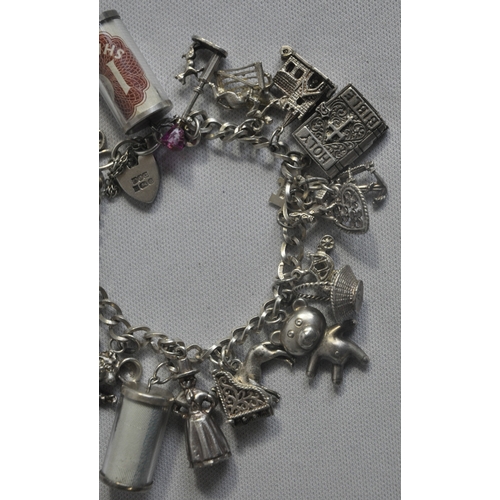 241 - SILVER CHARM BRACELET WITH CHARMS - SOME SILVER (TOTAL WEIGHT 61.1g)