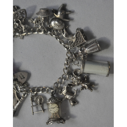 241 - SILVER CHARM BRACELET WITH CHARMS - SOME SILVER (TOTAL WEIGHT 61.1g)