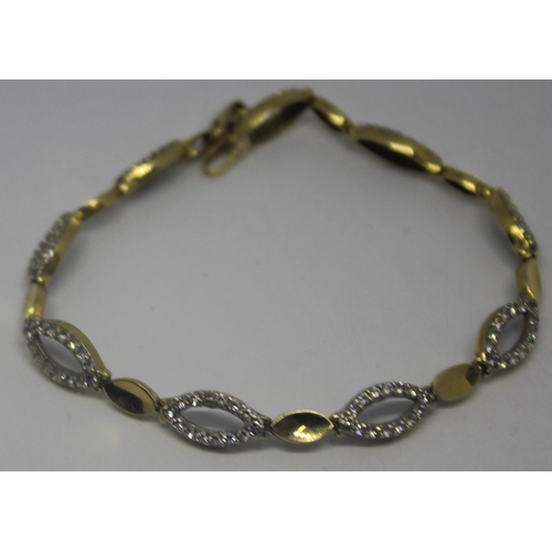 217 - 18ct GOLD BRACELET SET CLEAR STONES (MARKED 750) 10.2g