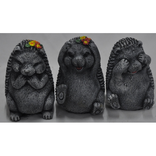 134 - 4 CONCRETE GARDEN ORNAMENT - 3 HEDGEHOGS (SEE, HEAR, SPEAK NO EVIL) AND FISH