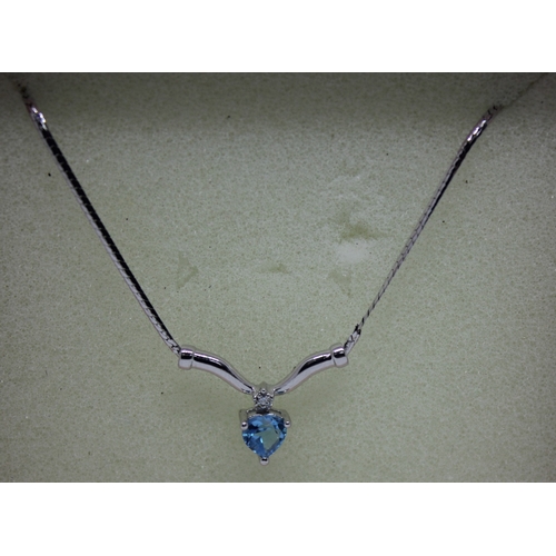 216 - 9ct WHITE GOLD BLUE TOPAZ PENDANT 16INCH (2.4G)