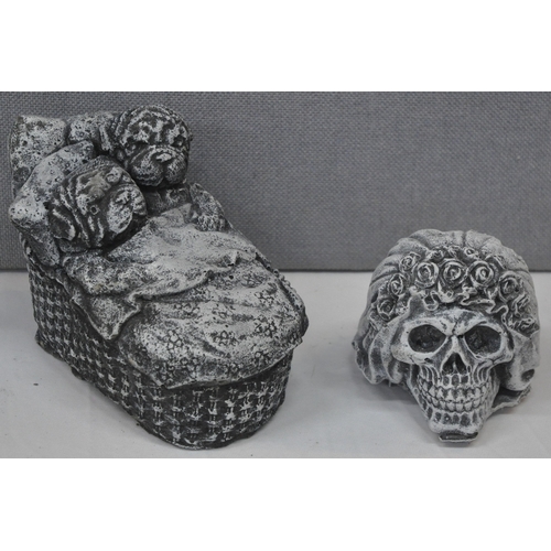 39 - 2 GARDEN ORNAMENTS - 1 PUPPIES IN BASKET, 1 SKULL AND 2 PLAQUES 