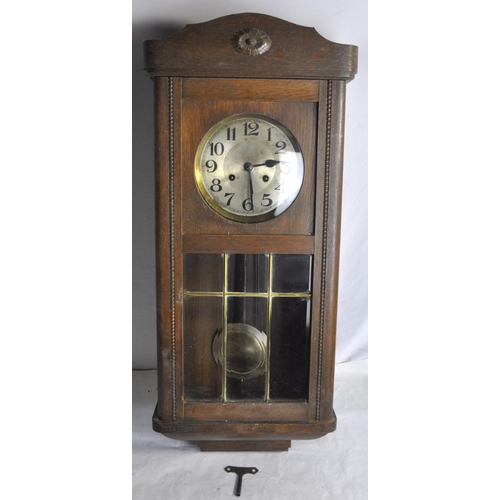 173 - OAK CASED PENDULUM WALL CLOCK WITH KEY