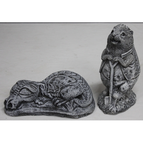 133 - 2 GARDEN ORNAMENTS - 1 SLEEPING DRAGON AND 1 HEDGEHOG WITH SHOVEL