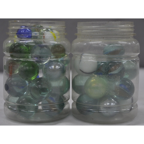 143 - 2 JARS OF GLASS MARBLES