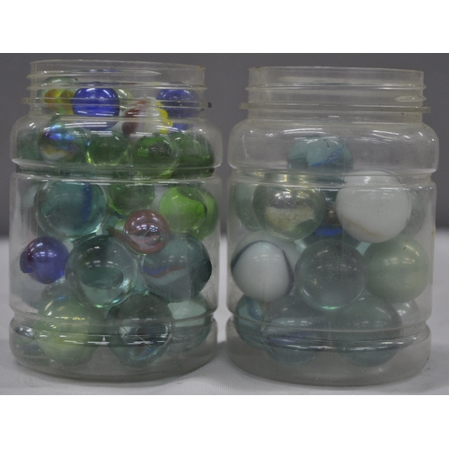 143 - 2 JARS OF GLASS MARBLES